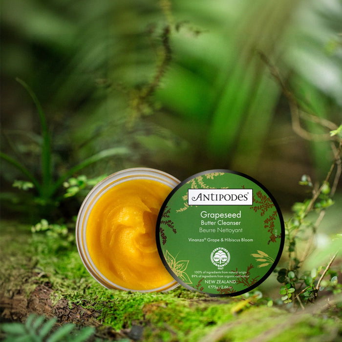 Antipodes Grapeseed Butter Cleanser jar with green label on a natural background