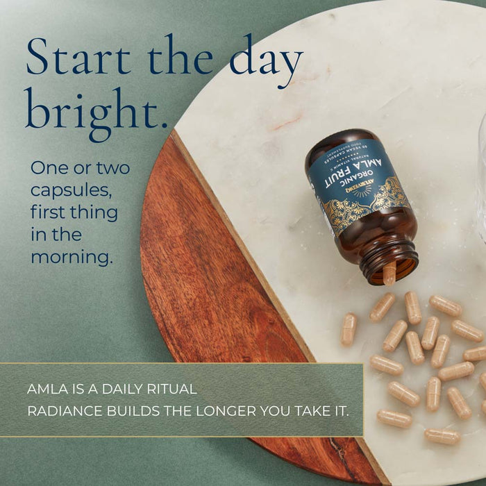 An open amber bottle of AMLA Organic Fruit Capsules. Large text reads 'Start the day bright.