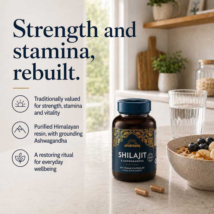 A bottle of Ayurvediq Shilajit capsules sits on a kitchen counter beside a glass of water and a bowl of oats with blueberries. Large marketing text on the left reads, 'Strength and stamina, rebuilt.