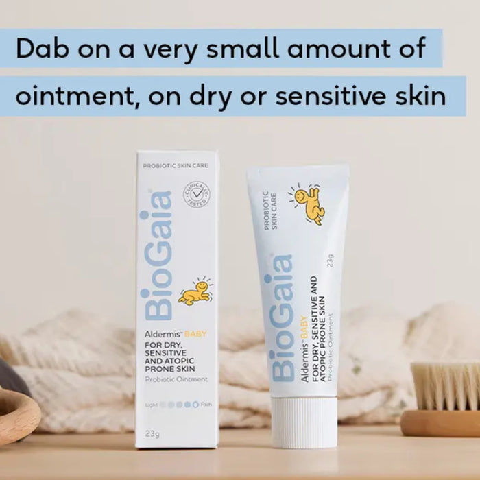 Two tubes of BioGaia ointment on a wooden surface with text about skin care.