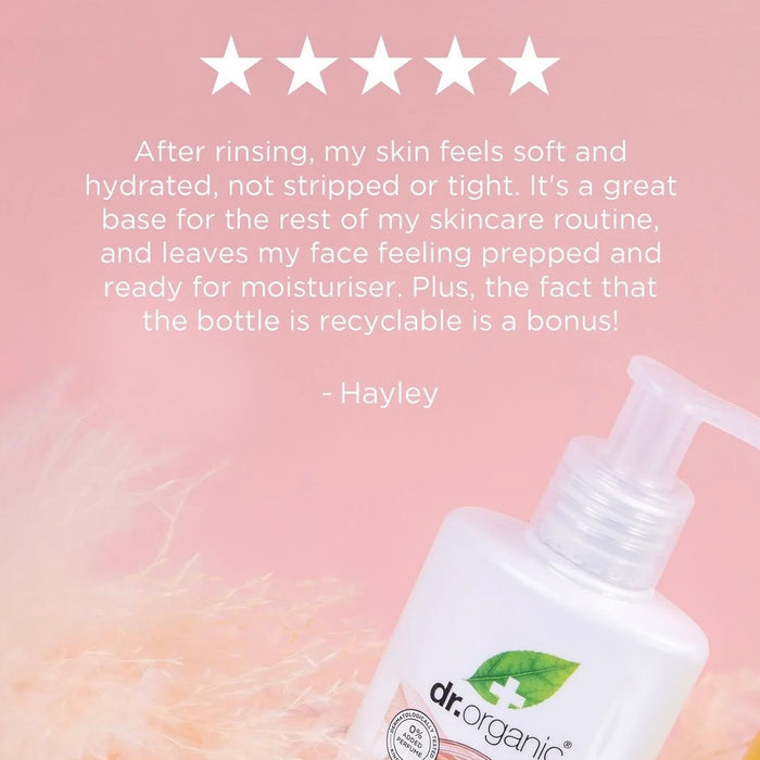 Dr. Organic skincare product with a five-star rating and customer review on a pink background