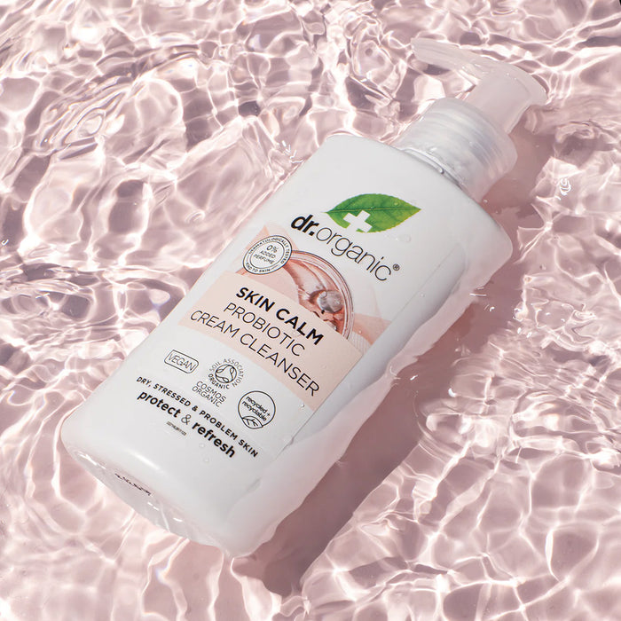 Dr. Organic Skin Calm Probiotic Cream Cleanser bottle on a water background