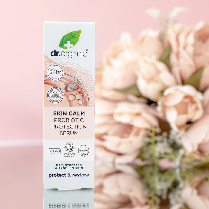 Dr. Organic Skin Calm Probiotic Protection Serum packaging with flowers in the background