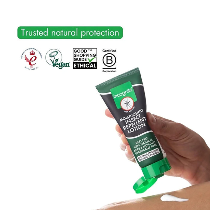 Hand holding a tube of Incognito insect repellent lotion with certification logos on a white background