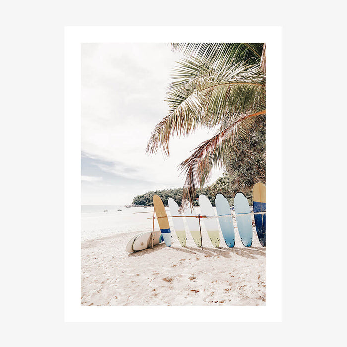 A photo wall art print featuring surfboards on the beach of a tropical Island coastline
