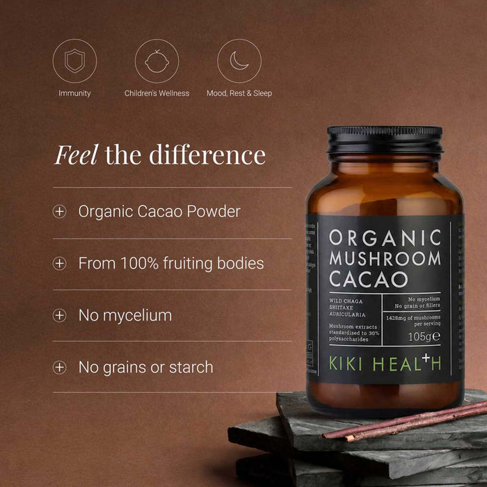 An amber glass bottle of Kiki Health Organic Mushroom Cacao supplement with a black label, displayed on a dark stone surface against a warm brown background with product benefits listed on the left.