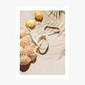 A photo wall art print featuring lemons on the beach