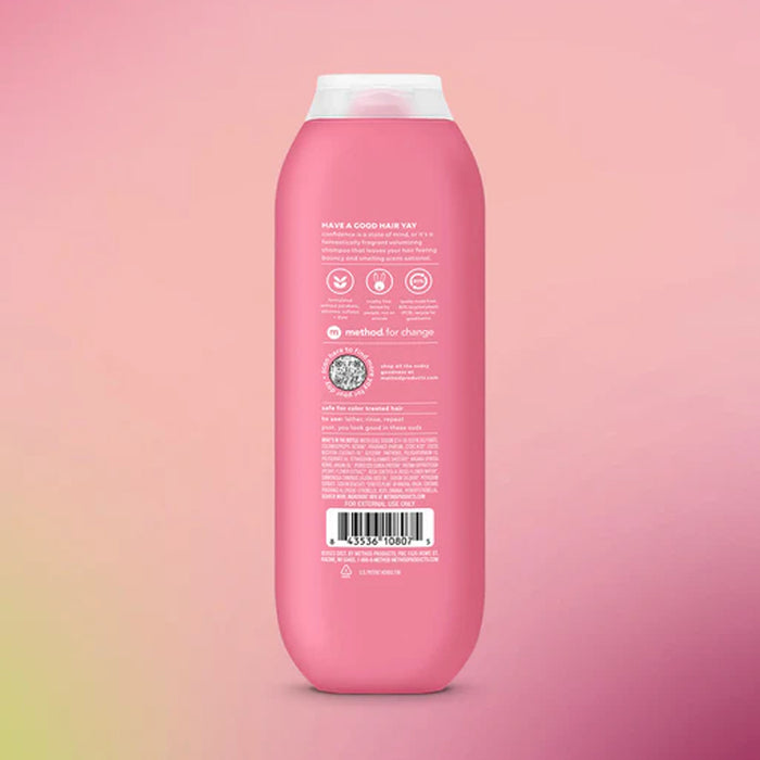 Pink shampoo bottle with label on a pink gradient background
