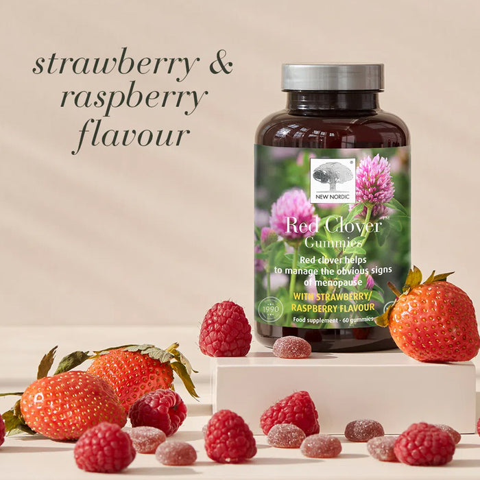 Bottle of Red Clover Gummies with strawberries and raspberries on a beige background