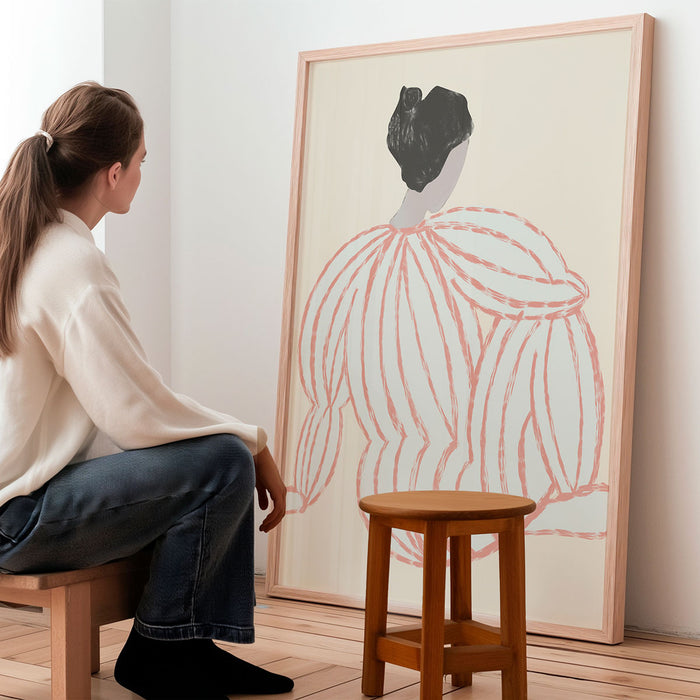 Woman sitting on a stool looking at a large framed abstract artwork in a minimalistic room.