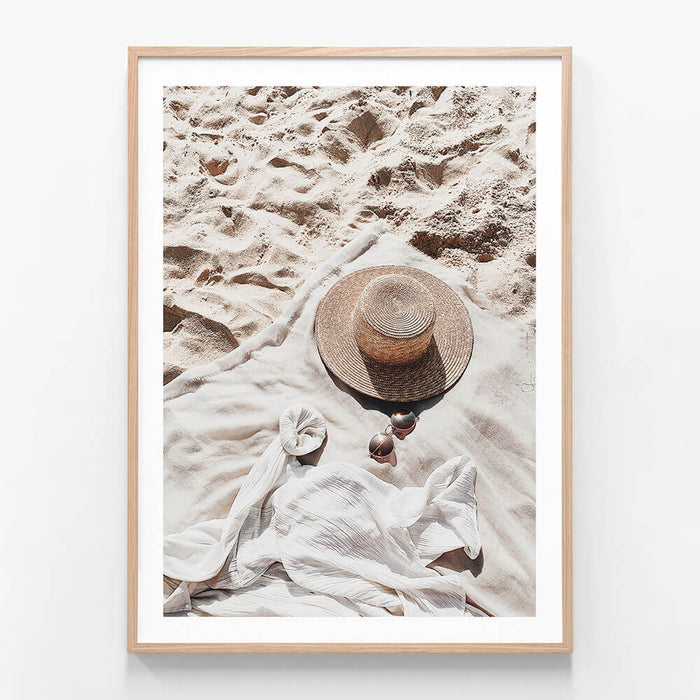 A framed photo wall art print featuring
Summer Afternoon at the beach with a hat and sun glasses
