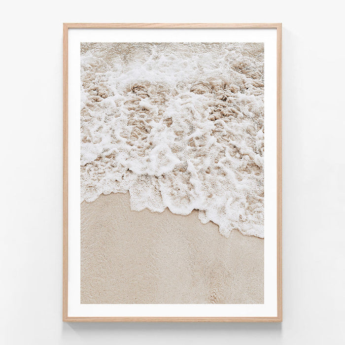 A framed photo wall art print featuring a close up of the tide coming in on the sand