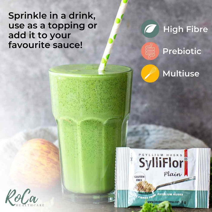 A green smoothie in a clear glass with a green-and-white striped straw, shown next to a SylliFlor Plain protein powder packet. Text on the image says it can be sprinkled in a drink, used as a topping, or added to sauce, with benefits listed as high fibre, prebiotic, and multiuse.