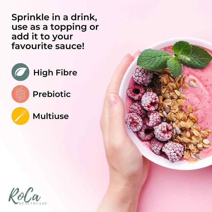 A hand holds a white bowl filled with pink smoothie, topped with fresh raspberries, mint leaves, and granola. Text on the left explains how to use the product: 'Sprinkle in a drink, use as a topping or add it to your favourite sauce!' with icons for High Fibre, Prebiotic, and Multiuse.