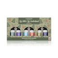 Tisserand 'Winter Wonderland' diffuser oils gift set in a decorative green box with Christmas tree illustrations. The set contains six essential oils in blue, purple, light blue, red, and green bottles, displayed against a clean white background with a soft reflection.