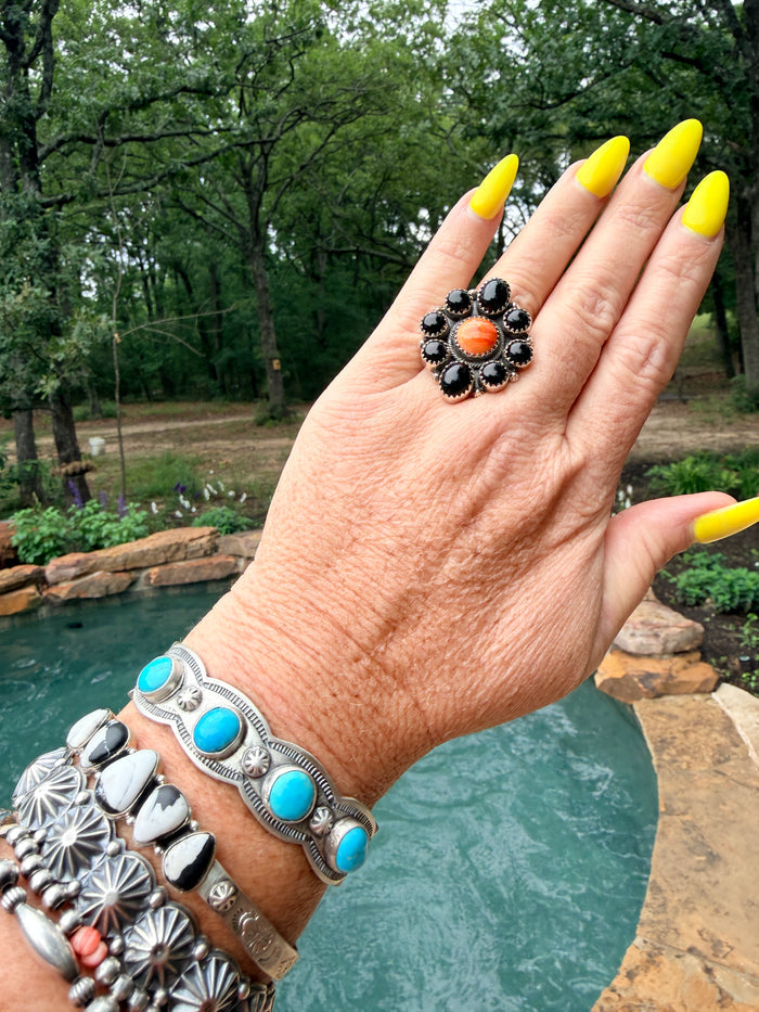 Tony Yazzie 8 Onyx Stones Surrounded by Orange Spiny Oyster with Sterling Silver detailed band. Adjustable Ring