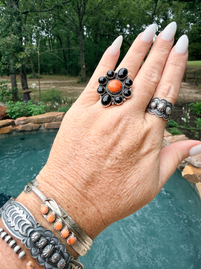 Tony Yazzie 8 Onyx Stones Surrounded by Orange Spiny Oyster with Sterling Silver detailed band. Adjustable Ring
