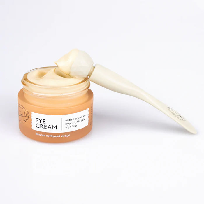 Jar of UpCircle Eye Cream with a applicator on a white background