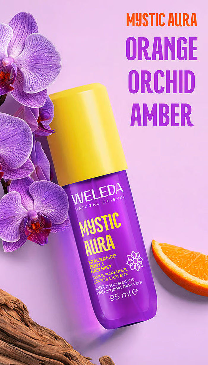 A bottle of Weleda Mystic Aura fragrance oil in Orange Orchid Amber scent.