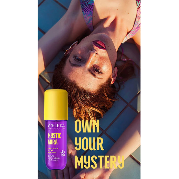 A woman lying on ground with a bottle of Weleda Mystic body and hair mist.