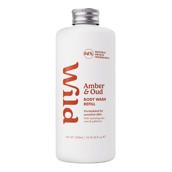 A 300ml white bottle of Wild Body Wash Refill in the Amber & Oud scent, featuring a silver screw cap and orange-red text on a clean white background.