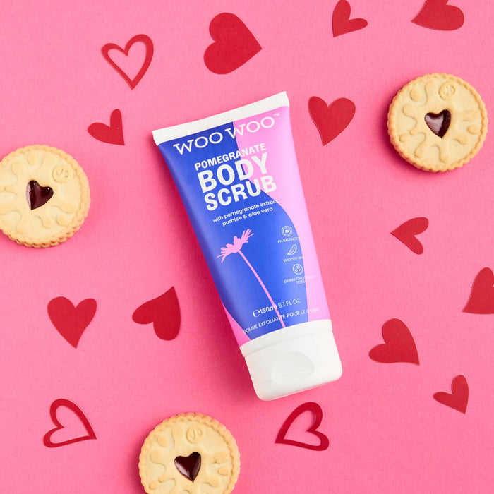 Woo Woo pomelo body scrub tube on a pink background with heart shapes and cookies.