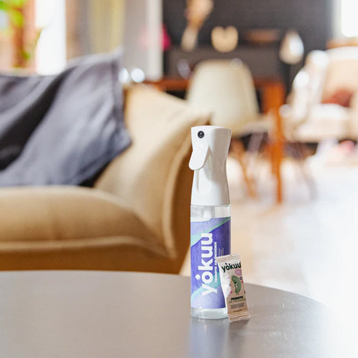 Two bottles of Yokuu on a table with a blurred living room background